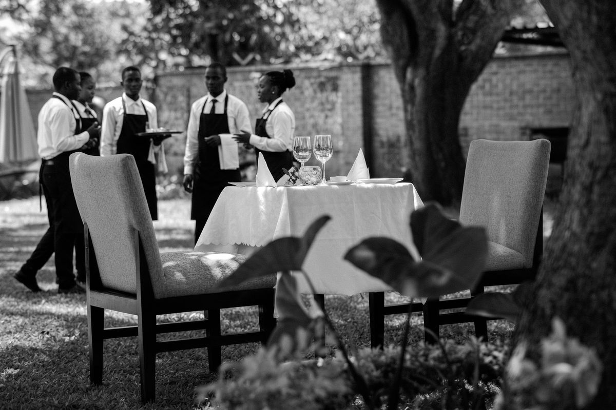 Waiting staff preparing an outdoor garden table at a café